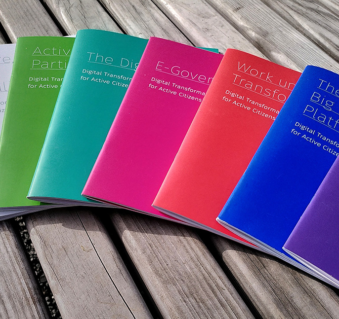 colourful booklets on a wooden table