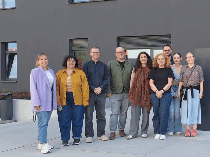 A group of people standing in front of a building