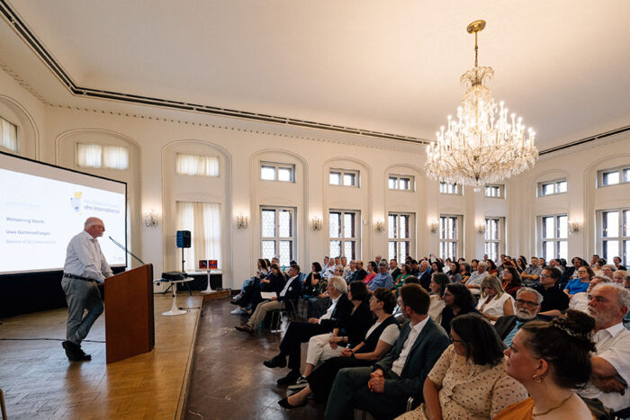 a speaker in podium and audience